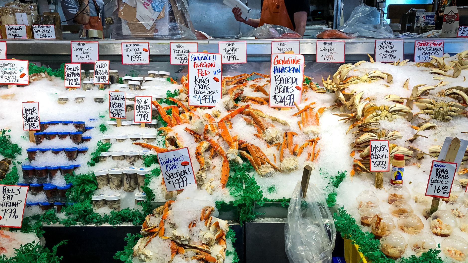 Fresh seafood display with crabs and oysters at a market in Seattle.